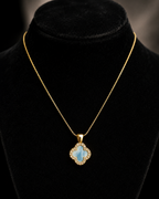 Gold-Tone Blue Quatrefoil Pendant Necklace with Crystal-Like Border