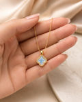 Gold-Tone Blue Quatrefoil Pendant Necklace with Crystal-Like Border